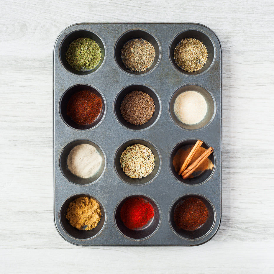 Spices in small bowls on a kitchen counter