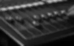 Close-up of audio mixer faders used to control event sound levels and amplified audio volume
