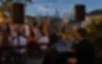 AV technician managing speakers and sound levels at an outdoor Nashville event with city skyline in the background