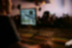 Live event technician troubleshooting audio issues at a digital mixing console with a large crowd in the background