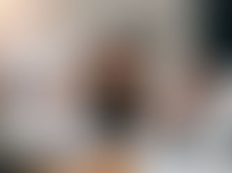 Stressed businesswoman surrounded by coworkers pointing at documents, symbolizing workplace pressure and lack of support.