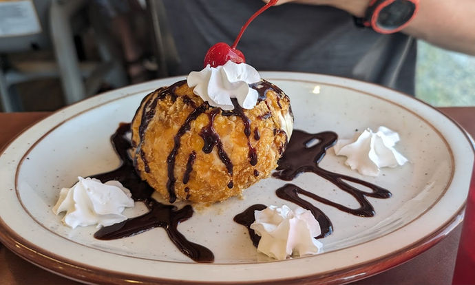 Homemade Fried Ice Cream drizzled lightly with chocolate.
