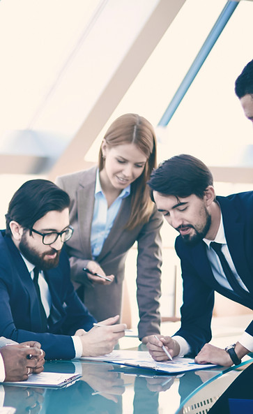 People gathered around a table having a business discussion