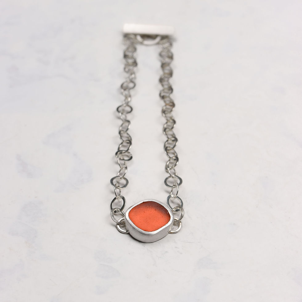 Thumbnail: Orange sea glass and silver chain bracelet on a white background