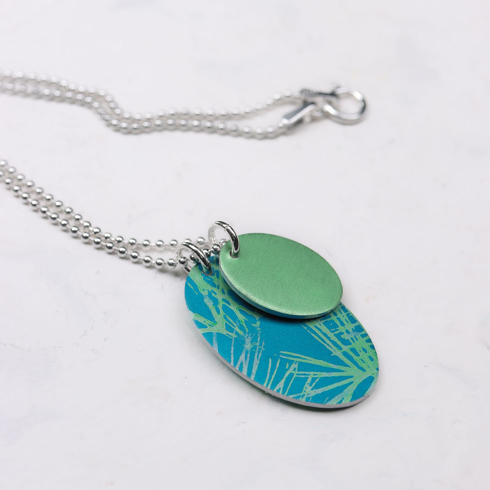 Thumbnail: Teal blue and green oval silver duo cluster necklace on a white background