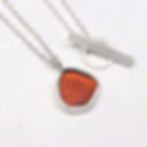 Thumbnail: Dark orange sea glass and silver pendant necklace  on a white background