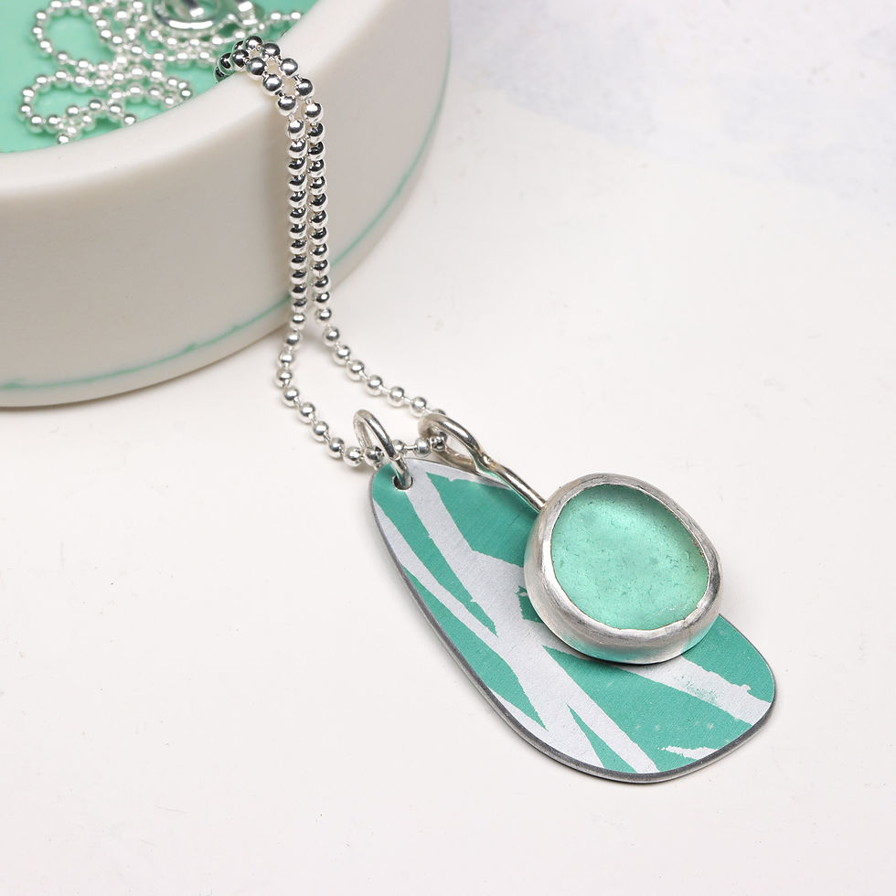 Thumbnail: Aqua green sea glass aluminium and silver cluster necklace on a white background with trinket dish
