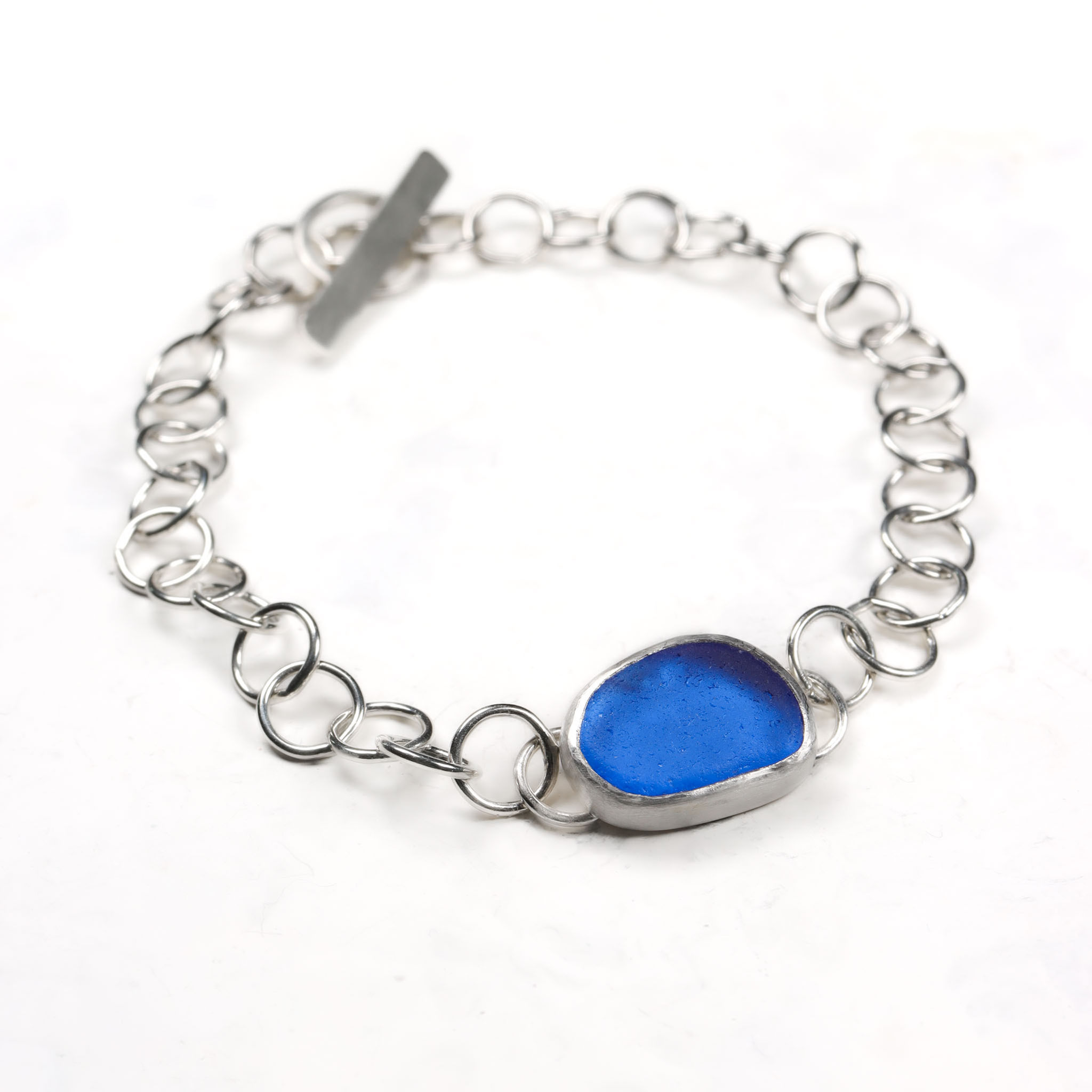 Cobalt blue and silver chain bracelet on a white background