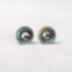 Teal and orange aluminium and silver interchangeable stud earrings on a white background