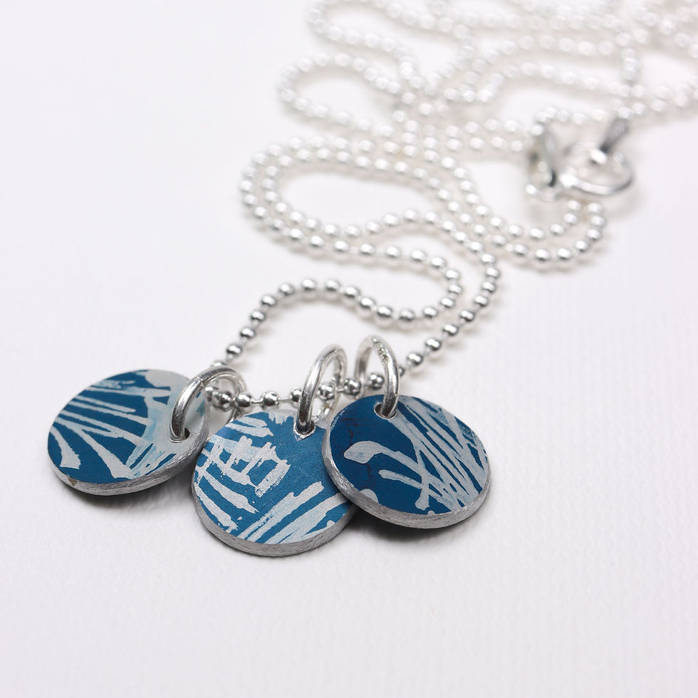Thumbnail: Back view of midnight blue and silver mini trio disc necklace on a white background