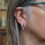 Thumbnail: Purple and turquoise anodised aluminium and silver 3 hoop earrings on a white woman