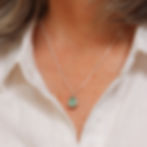 Thumbnail: Seafoam blue sea glass and silver minimalist pendant necklace on a white woman wearing a cream linen shirt