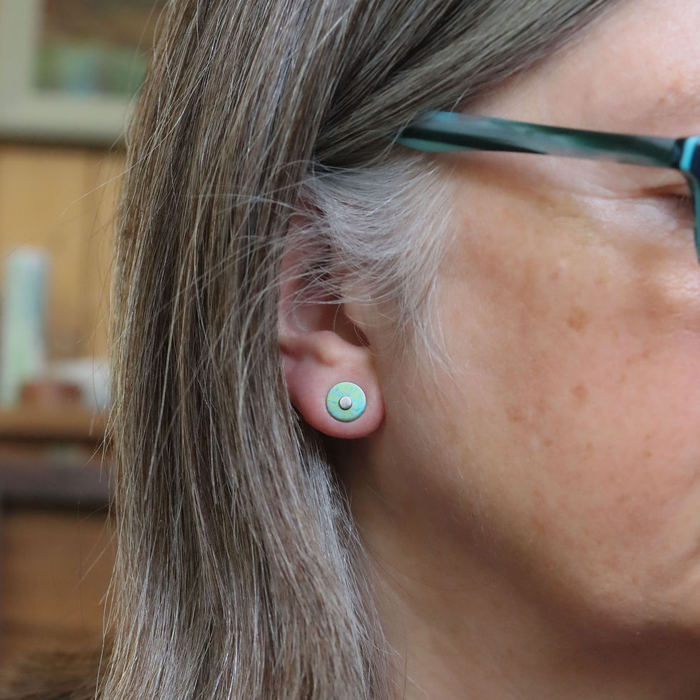 Thumbnail: Green and turquoise round silver stud earrings on a white woman