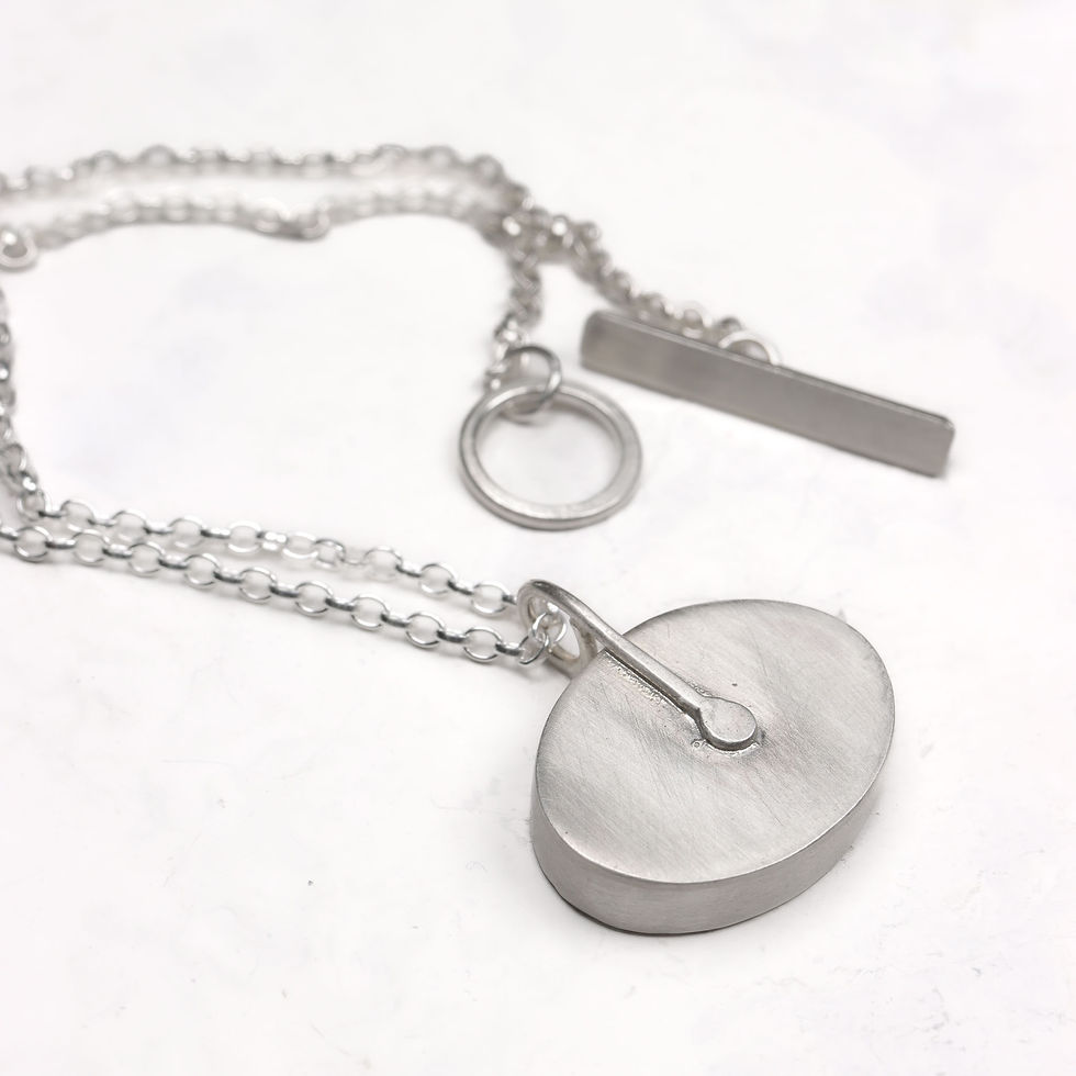 Thumbnail: Back view of blue sky cloud aluminium and silver oval pendant necklace on a white background