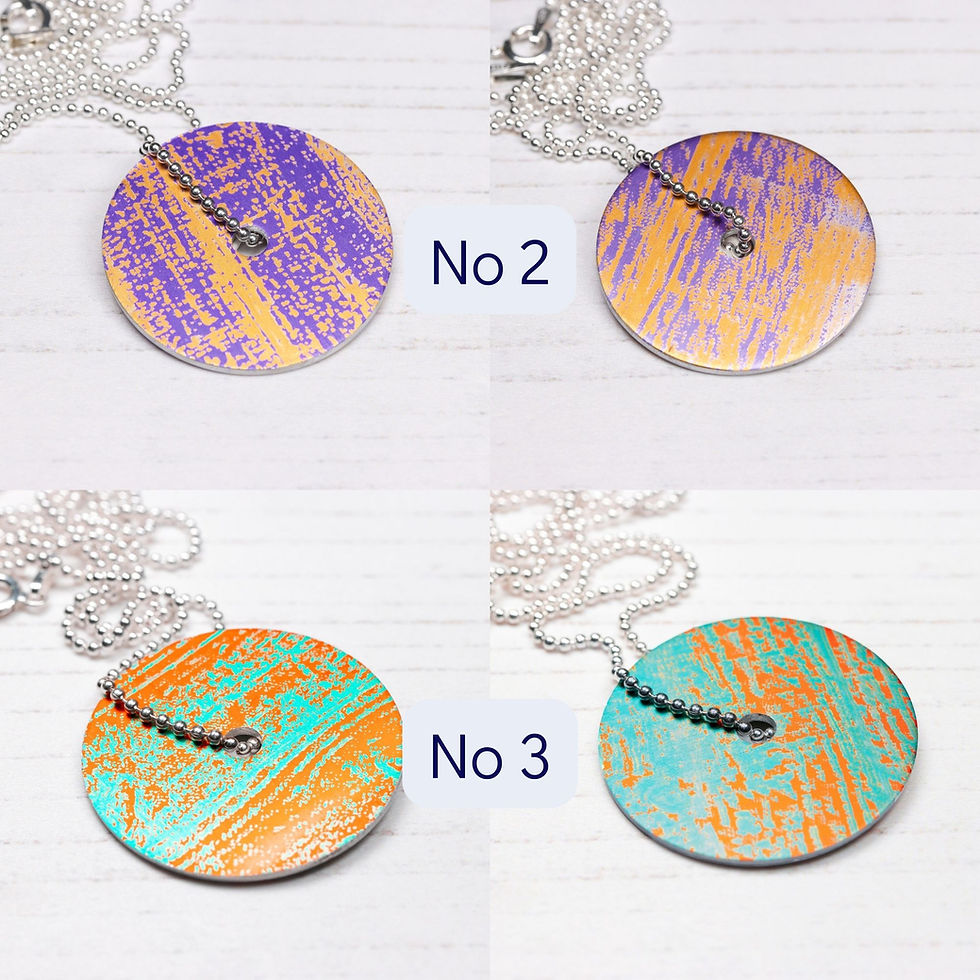 Thumbnail: Colourful handprinted aluminium disc pendant necklace on a white background