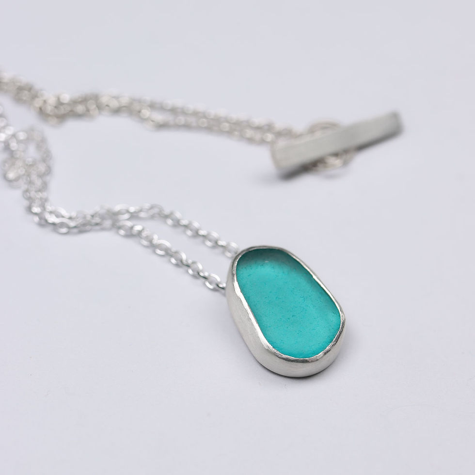 Thumbnail: Turquoise blue sea glass and silver pendant necklace on a white background