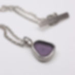 Thumbnail: Small purple sea glass and silver necklace on a white background