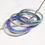 Thumbnail: Turquoise and purple aluminium and silver 5 hoop necklace on white background