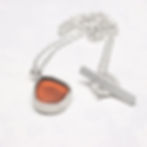 Thumbnail: Dark orange sea glass and silver pendant necklace  on a white background