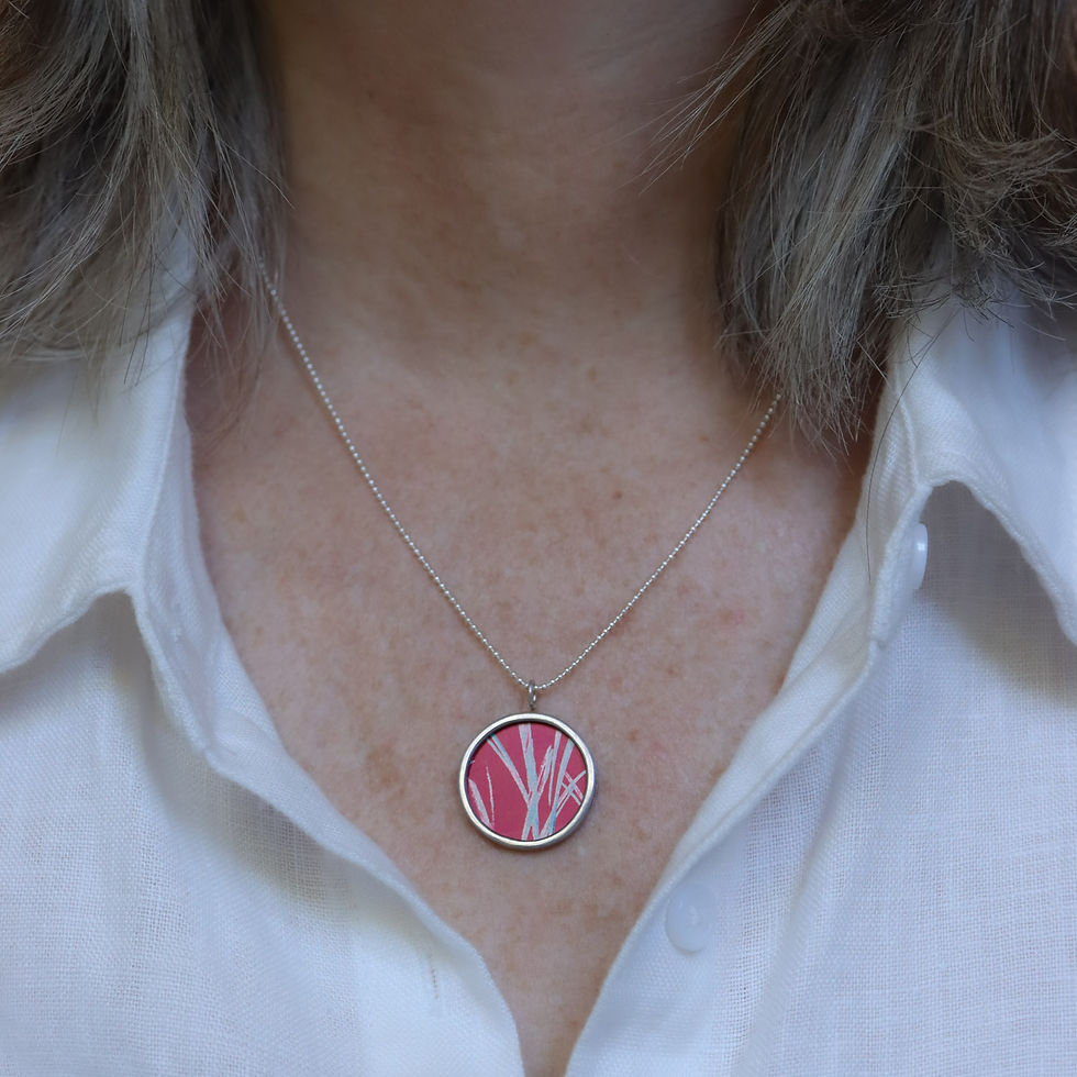 Thumbnail: Red and turquoise aluminium and silver rivet necklace on a white woman wearing a cream linen shirt