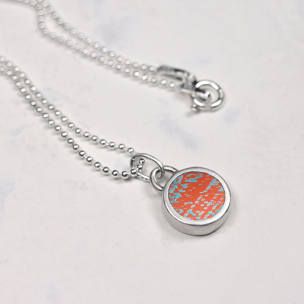 Thumbnail: Orange and silver necklace on white background