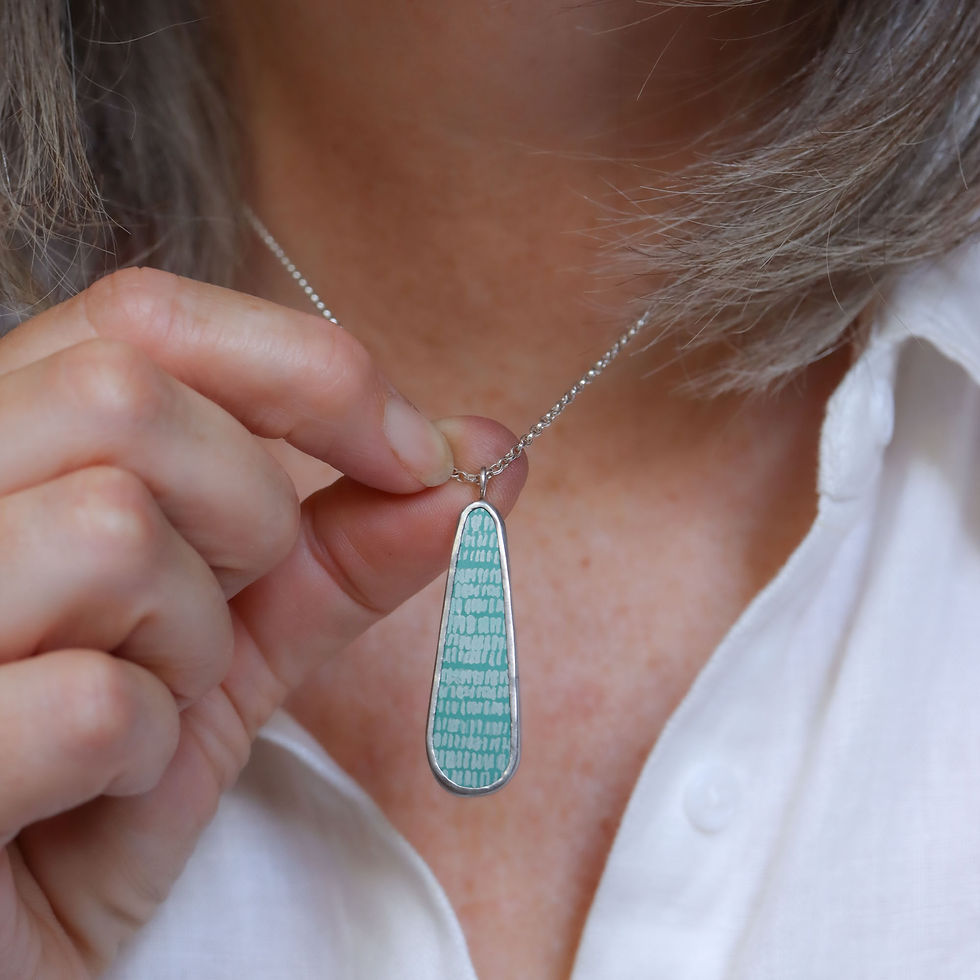 Thumbnail: Aqua green aluminium and silver teardrop pendant necklace on a white woman