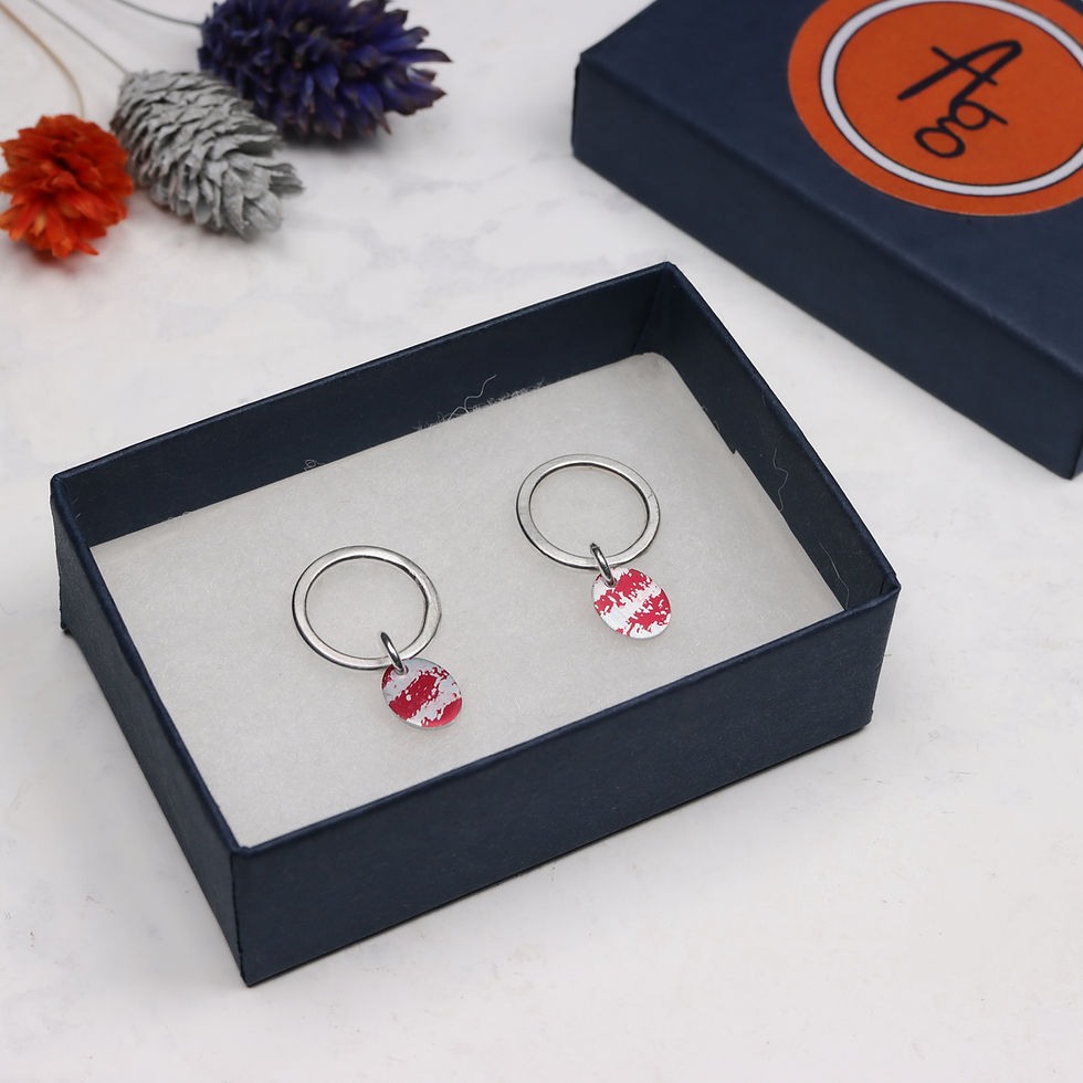 Thumbnail: Red and silver oval drop earrings in open jewellery box with lid and dried flowers behind