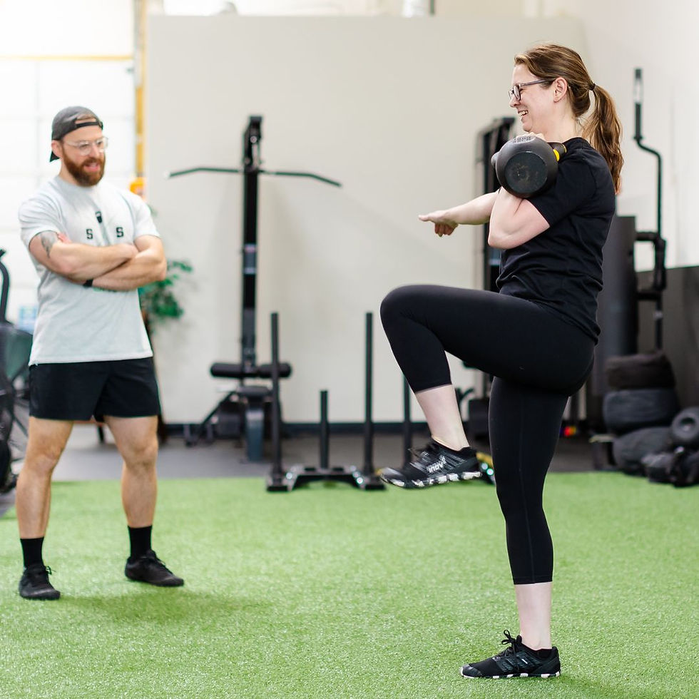 Straight Shot Training coach leading a kettlebell session with a client in the Frederick Maryland gym, demonstrating one on one personal training