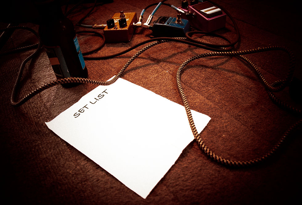 Blank set list on a stage for live performance with guitar instrument cable, guitar effect