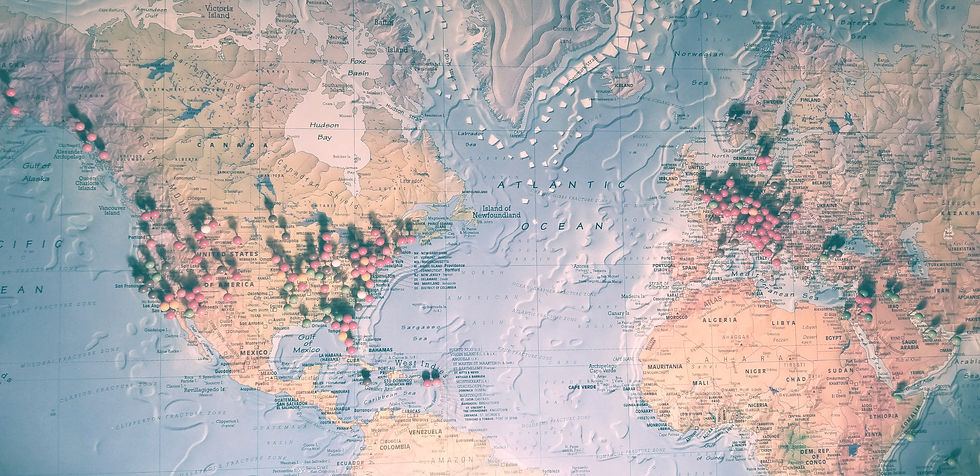 A soft-color world map filled with multi-colored pins as the background for the text.