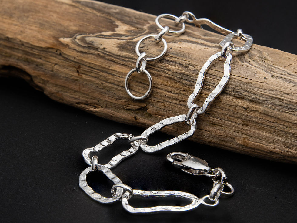 Thumbnail: Artisan sterling silver bracelet reflecting light with unique organic finish