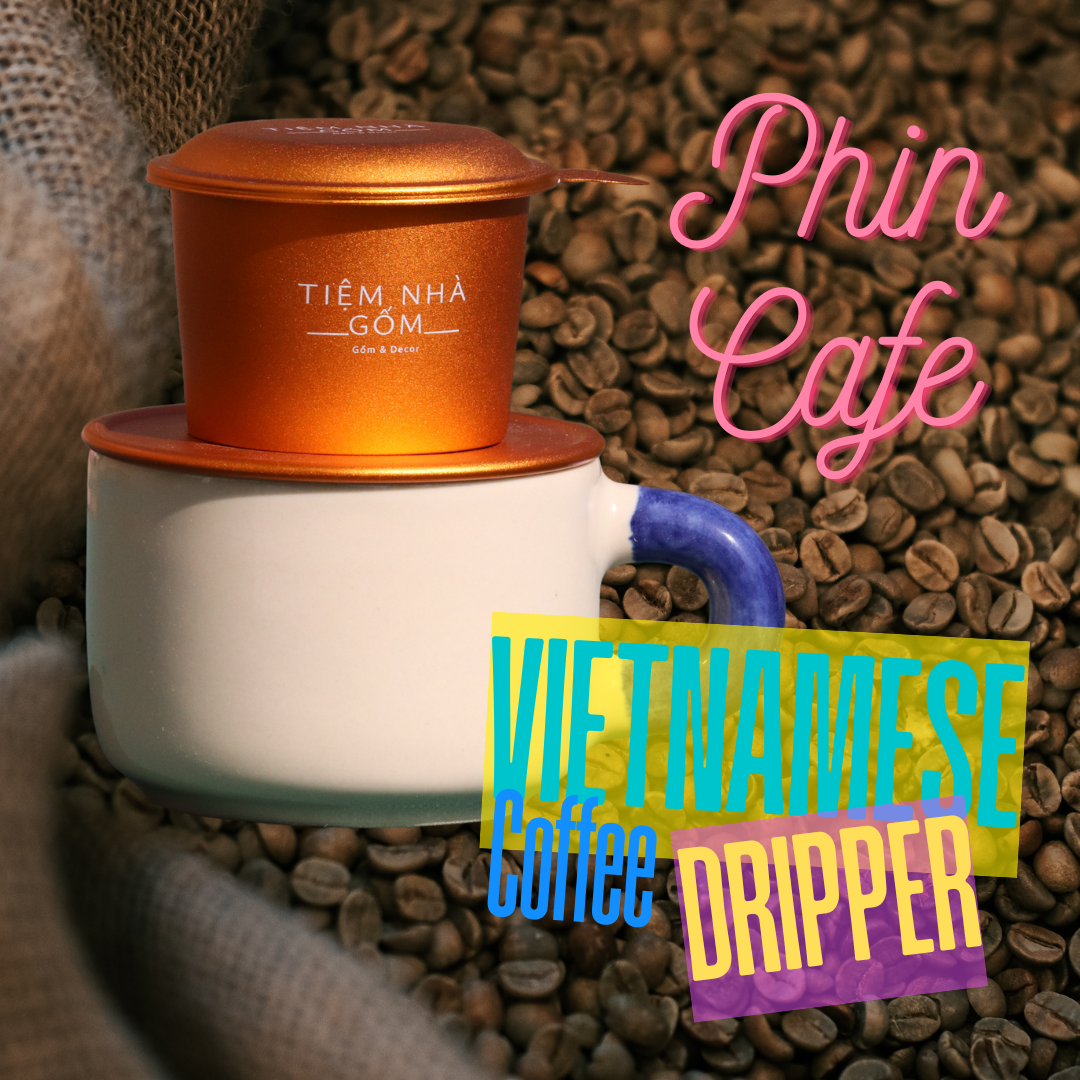 Burnt Orange Vietnamese Phin Cafe coffee dripper sits on a blue coffee mug with coffee beans in background