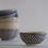 Thumbnail: Y Thanh hand painted ceramic rice bowl with raindrop indigo pattern with stack of different pattern rice bowls in background