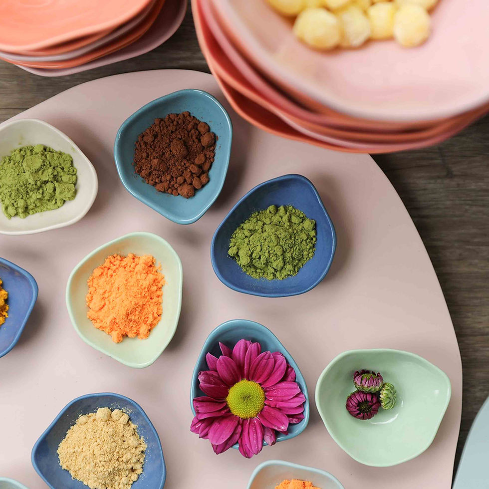 Thumbnail: colourful pinch pots with spices, a flower sit on top of a table