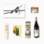 Products for the By Candlelight gift box which include wine, candle, hand lotion and chocolate.