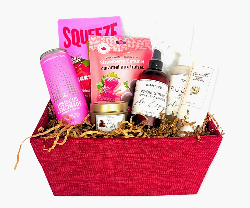 Red gift basket with a bag of marshmallows, freeze dried strawberries, soda, candle and lotion plus room spray and hand soap. All from businesses in BC.