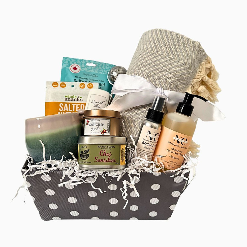 Grey polka dot gift basket with blanket, pottery mug, nuts, chocolates, tea, candle, room spray and hand soap.