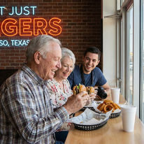 Family eating burgers, onion rings at "NOT JUST BURGERS" El Paso, Texas.
