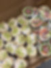 Assorted catering wraps sliced in half and arranged in a tray for serving.
