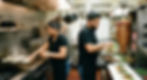 Chefs cooking tortillas and preparing tacos from a trompo