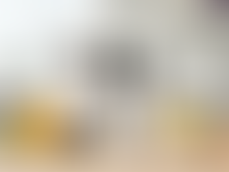 Three Yeshua Skin products, including Vitamin C cleanser, serum, and toner, are displayed with orange and lemon slices and flower petals.