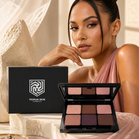 Elegant woman poses with Yeshua Skin Cosmetics makeup palette and box in a warm beige setting, looking calm and poised