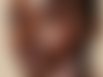 Close-up of a woman with glossy lips holding a pink "YESHUA Skin Cosmetics" tube. Background is light beige, with elegant, glowing makeup.