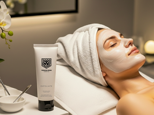 Woman relaxing with a facial mask in a spa setting. Exfoliate cream by Yeshua Skin on a table with white bowls and an orchid nearby.