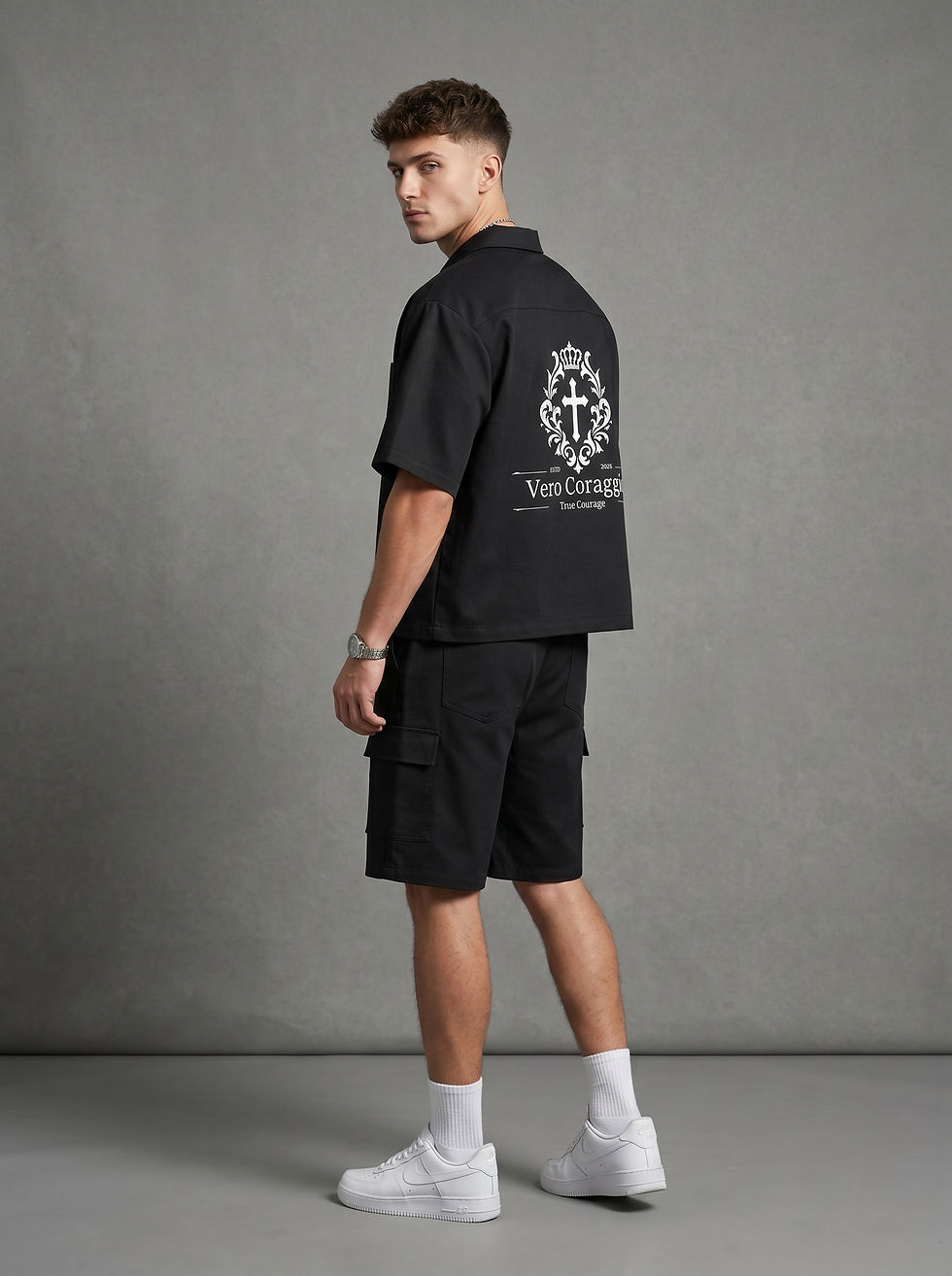 Male model wearing YESHUA Apparel black cargo shorts
