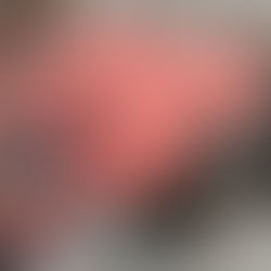 Fashion items on display: a pink "SACRED Love" shirt, camo sneaker, jewelry, sunglasses, REVIVAL magazine, and an open book.