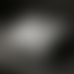 Folded white hoodie with a "YESHUA" patch lies on a marble slab. The dark marble background adds a modern, elegant touch.