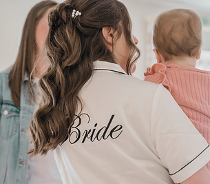 Bride on her wedding day have cuddles with her daughter whilst having nanny Laura on hand to attend to all of her needs