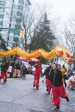 Ocean Tang guiding a dragon dance with a pearl