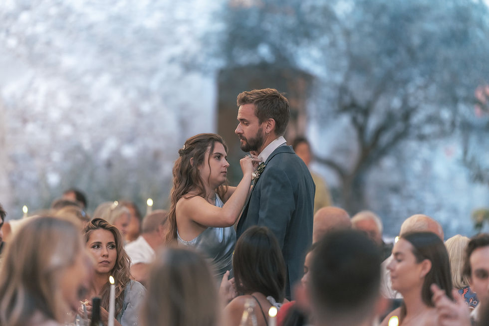 Guests enjoying drinks during an outdoor wedding reception.